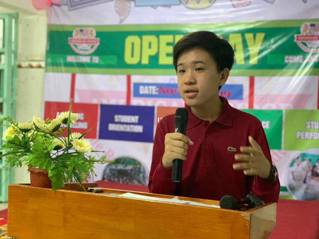 Nuon Hokseng speaking into a microphone at a school open day